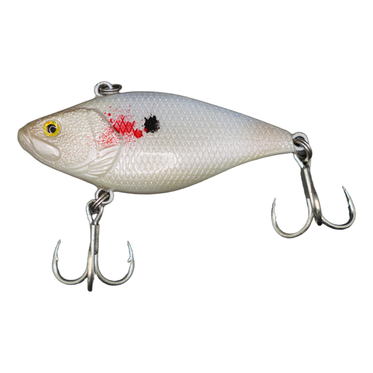 A realistic hard bait fishing lure shaped like a small fish, featuring a textured white and silver body with a red gill mark, a black spot, and a yellow eye. It is equipped with two silver treble hooks on a clean white background.
